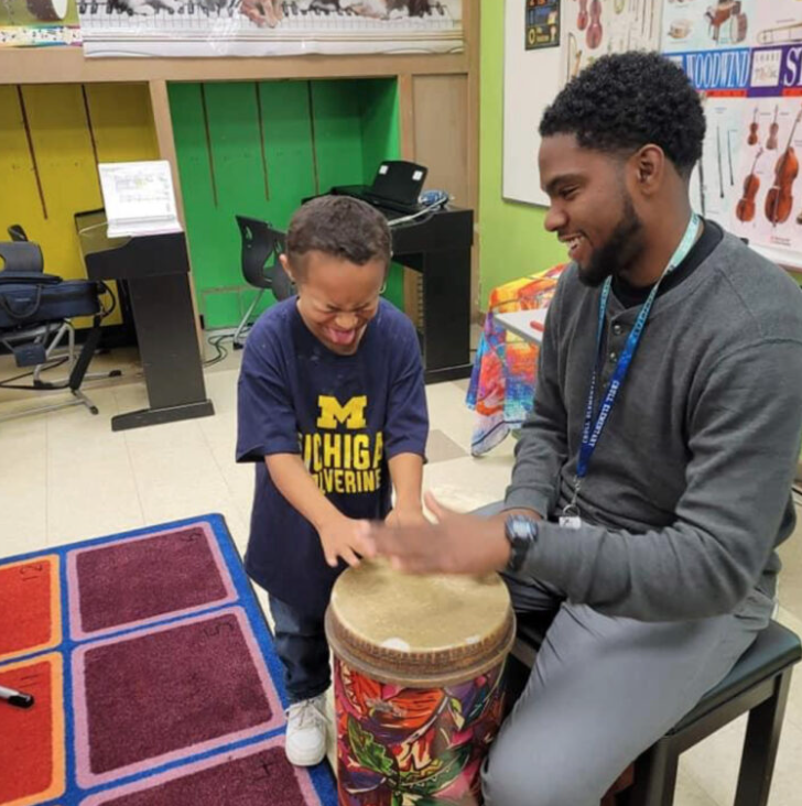 Cameron Lee teaching a student in music class
